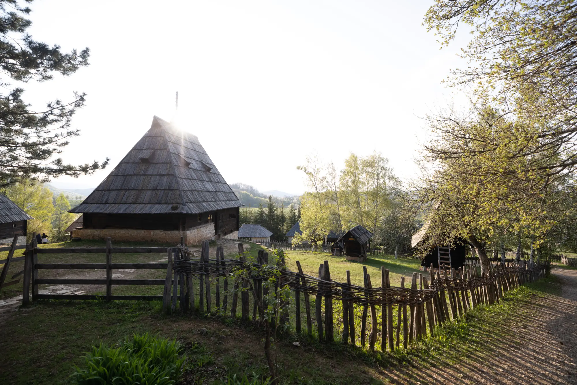 View of Sirogojno village on Zlatibor Mountain, Serbia, surrounded by green hills and traditional houses.