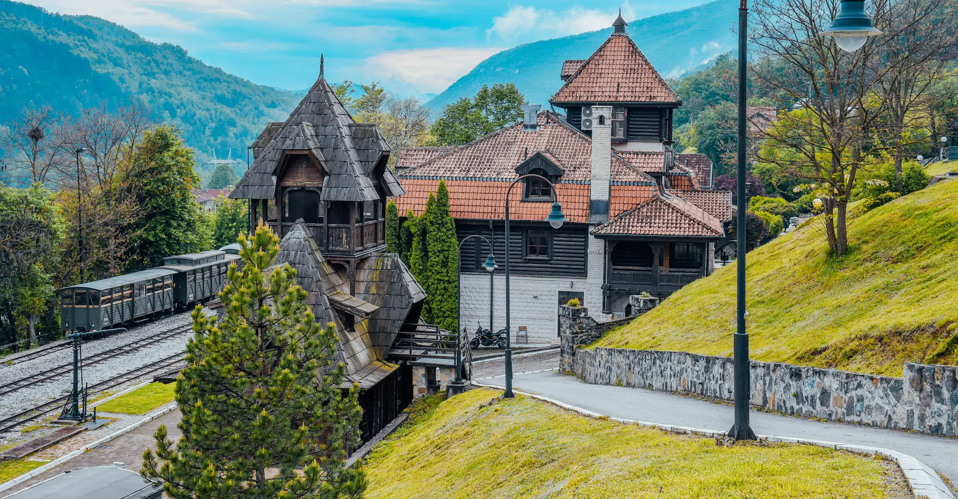 Train on the Šargan Eight railway in Mokra Gora, Serbia, winding through scenic landscapes.