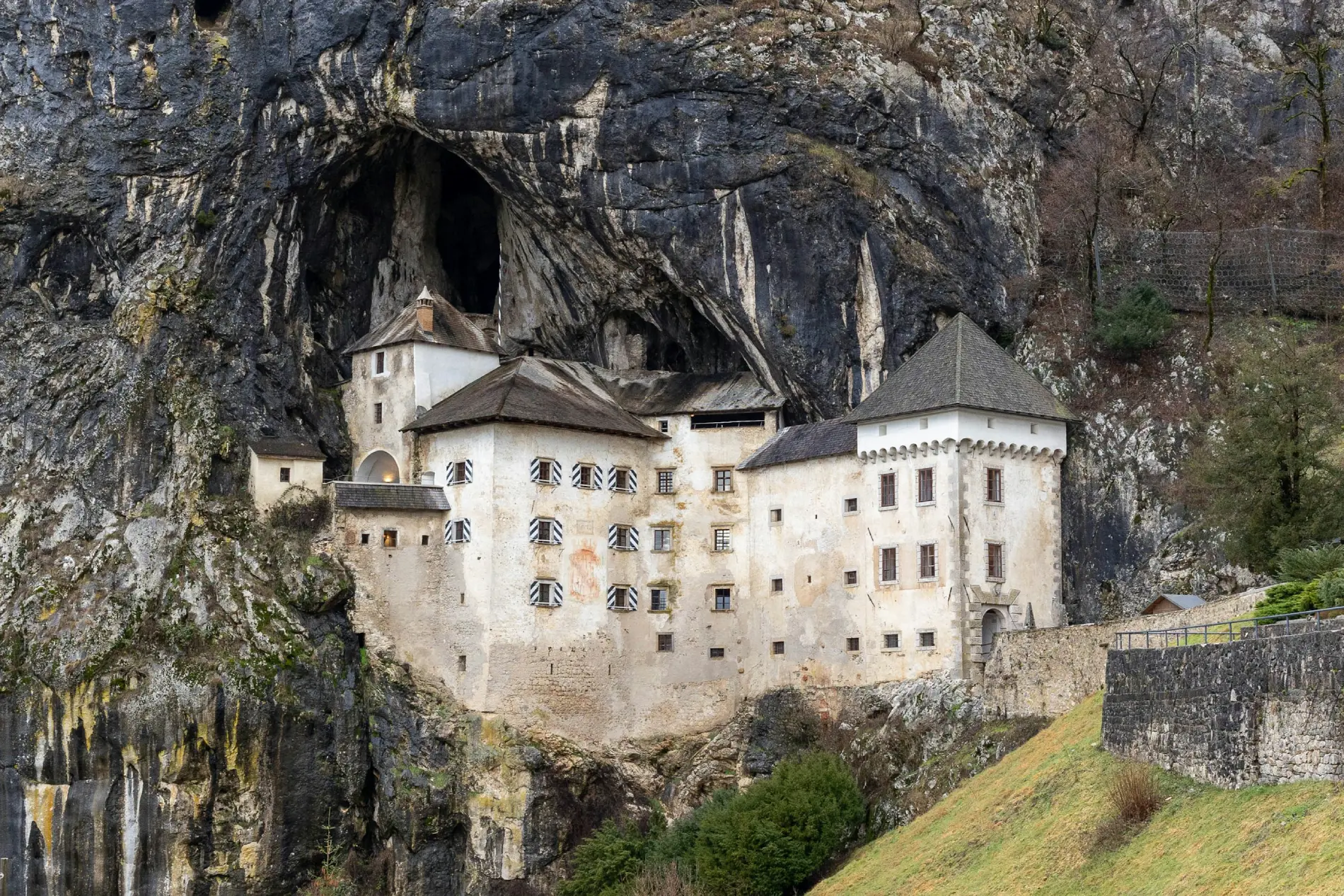 View of Postojna Cave and Predjama Castle in Slovenia, showcasing underground formations and the cliffside castle.